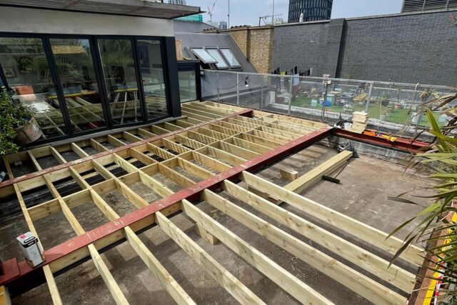 Flat roof conversion terrace garden builder Shoreditch London, installing a structure with structural joists & treated structural steels.